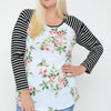 Floral Top Featuring Raglan Style Striped Sleeves And A Round Neck