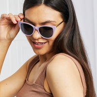 Cat-Eye Acetate Frame Sunglasses worn by a woman with long hair, showcasing a stylish purple frame.