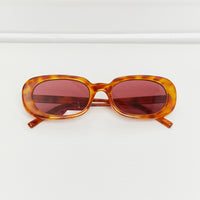 Oval Full Rim Sunglasses with orange tortoiseshell frame and red lenses, stylish UV protection.