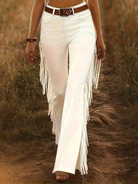 Model wearing Fringe Trim Flare Pants with pockets in a field, showcasing the stylish fringe detail.