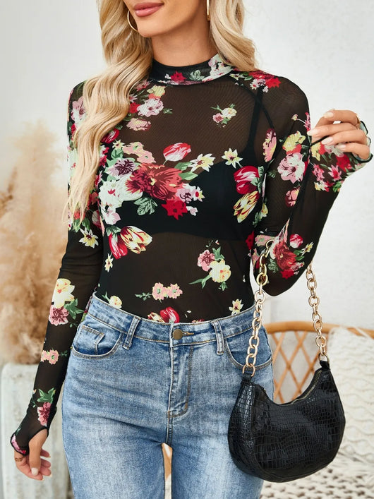 Floral Mock Neck Long Sleeve Top worn with jeans and a black purse, showcasing a floral design on a mesh fabric.