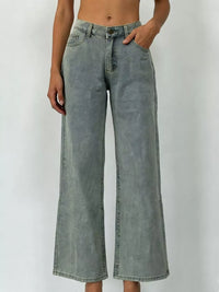 Wide Leg Washed Jeans featuring a pocketed design and a button closure in a light faded color.