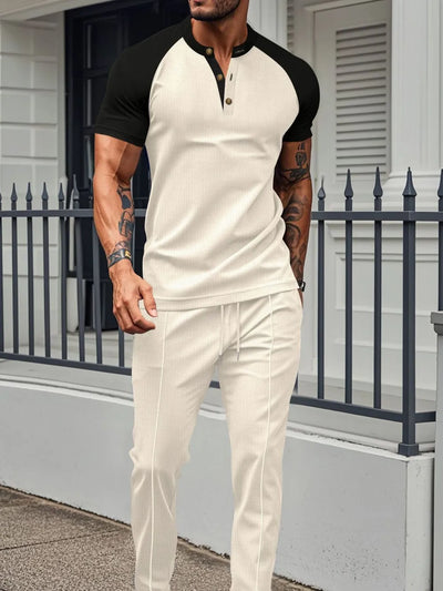 Men's Full Size Waffle-Knit Contrast Top and Drawstring Pants Set Plus Size modeled by a man in a stylish outdoor setting.