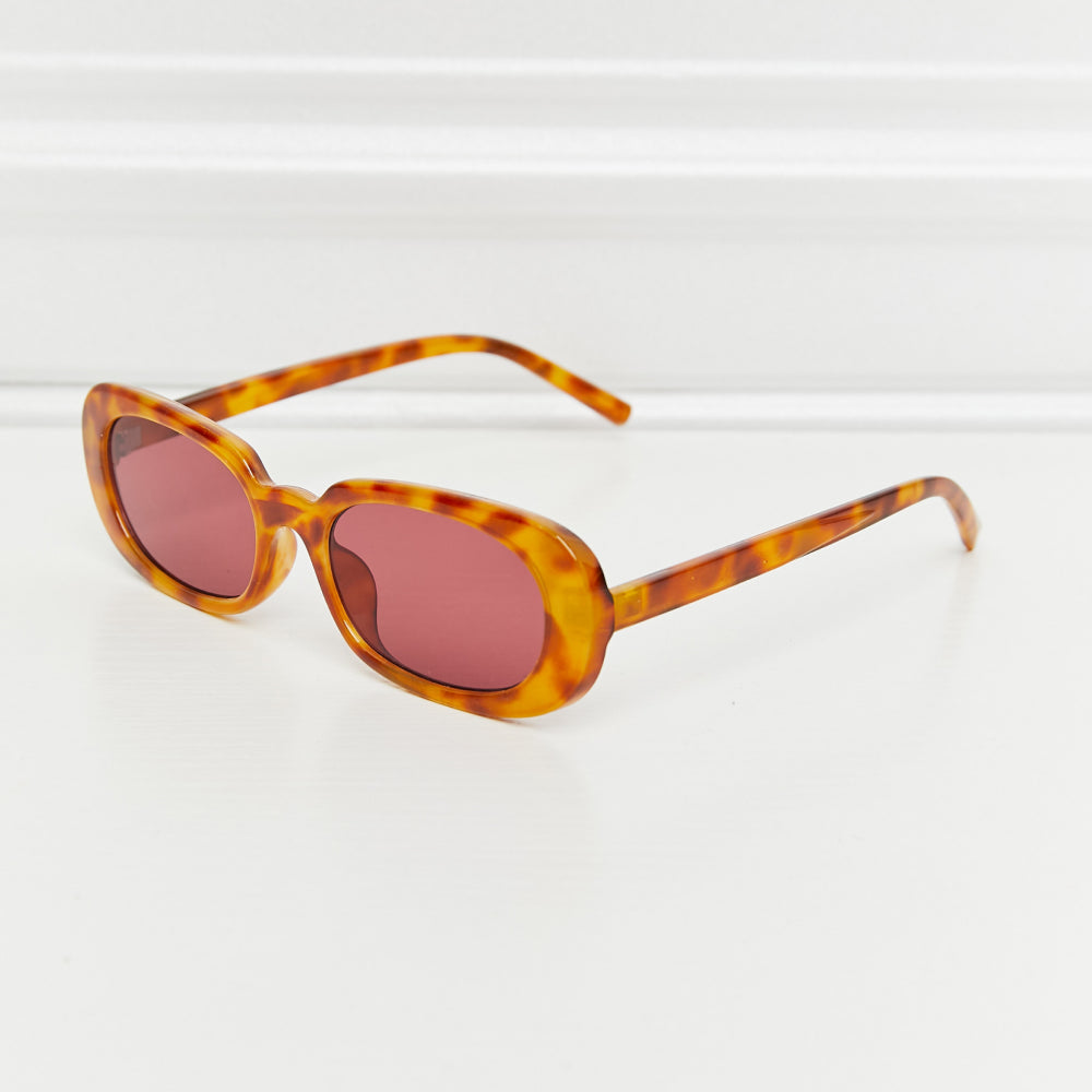 Oval Full Rim Sunglasses in tortoiseshell with pink lenses and polycarbonate frame.