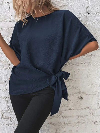 Knotted Round Neck Half Sleeve Blouse in navy blue, featuring a tied side detail and relaxed fit, styled with black pants.