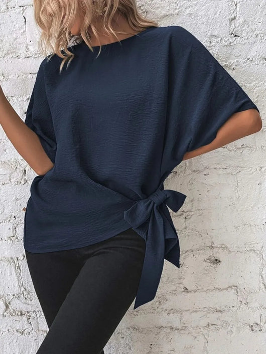 Knotted Round Neck Half Sleeve Blouse in navy blue, featuring a tied side detail and relaxed fit, styled with black pants.