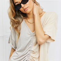 Model wearing Oval Full Rim Sunglasses with a chic beige and gray top, showcasing trendy summer fashion.