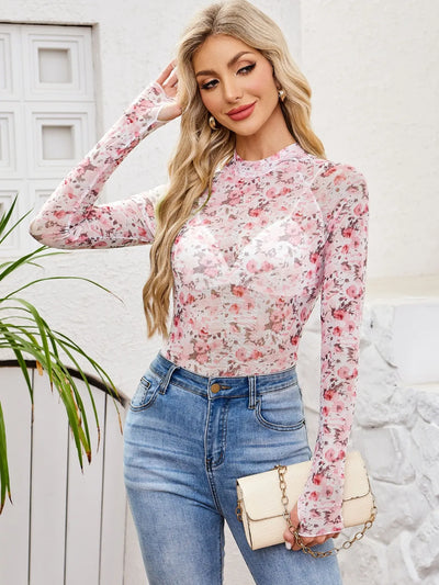 Floral Mock Neck Long Sleeve Top worn by a model, featuring a pink floral design and paired with jeans.
