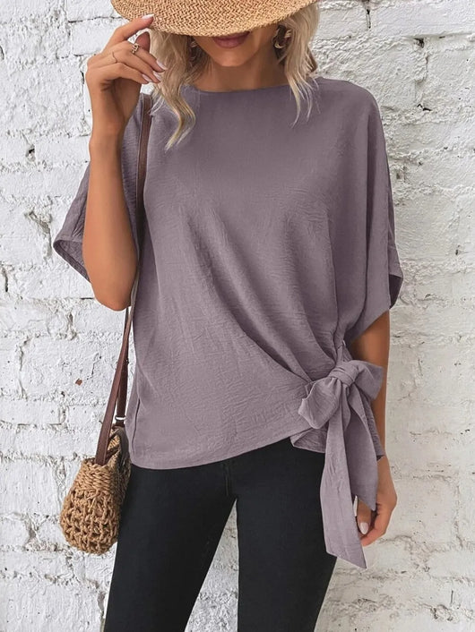 Knotted Round Neck Half Sleeve Blouse displayed on a model, featuring a tied design and a relaxed fit.