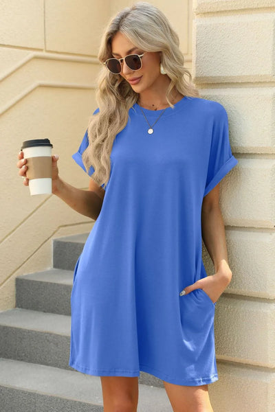 Florira Short Sleeve Mini Dress with Pockets in vibrant blue, featuring pockets, paired with sunglasses and a coffee.