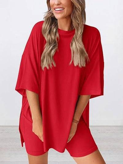 Full Size Oversized Slit Round Neck Top and Shorts Lounge Set Plus Size in vibrant red color worn by a smiling model.