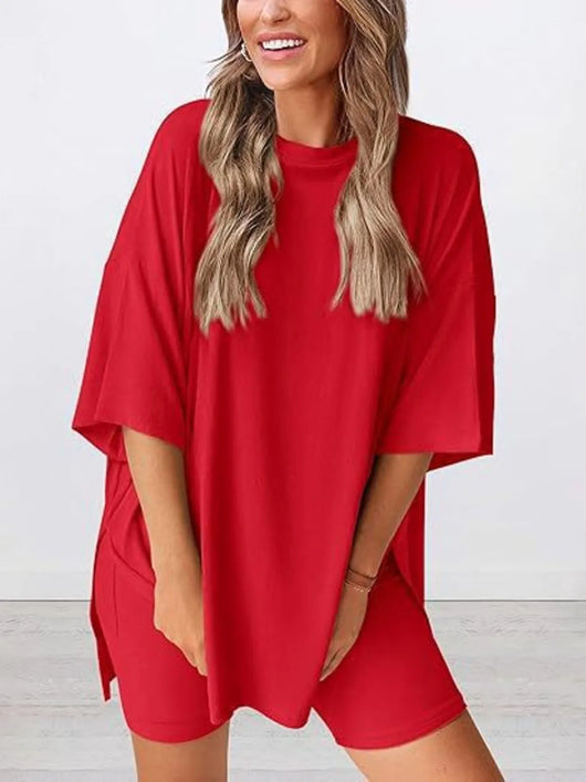 Full Size Oversized Slit Round Neck Top and Shorts Lounge Set Plus Size in vibrant red color worn by a smiling model.