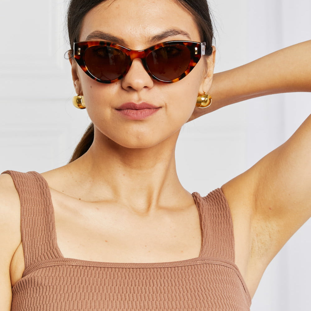 Model showcasing Tortoiseshell Acetate Frame Sunglasses with cat eye shape and UV400 protection.
