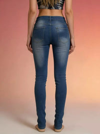 A model showcasing the back view of Distressed High Waist Jeans against a colorful background.