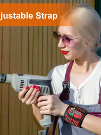 Woman holding a drill wearing a magnetic wristband with adjustable strap, showcasing a practical tool accessory for DIY projects.