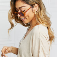 Oval Full Rim Sunglasses worn by a woman with long hair, showcasing a stylish look.