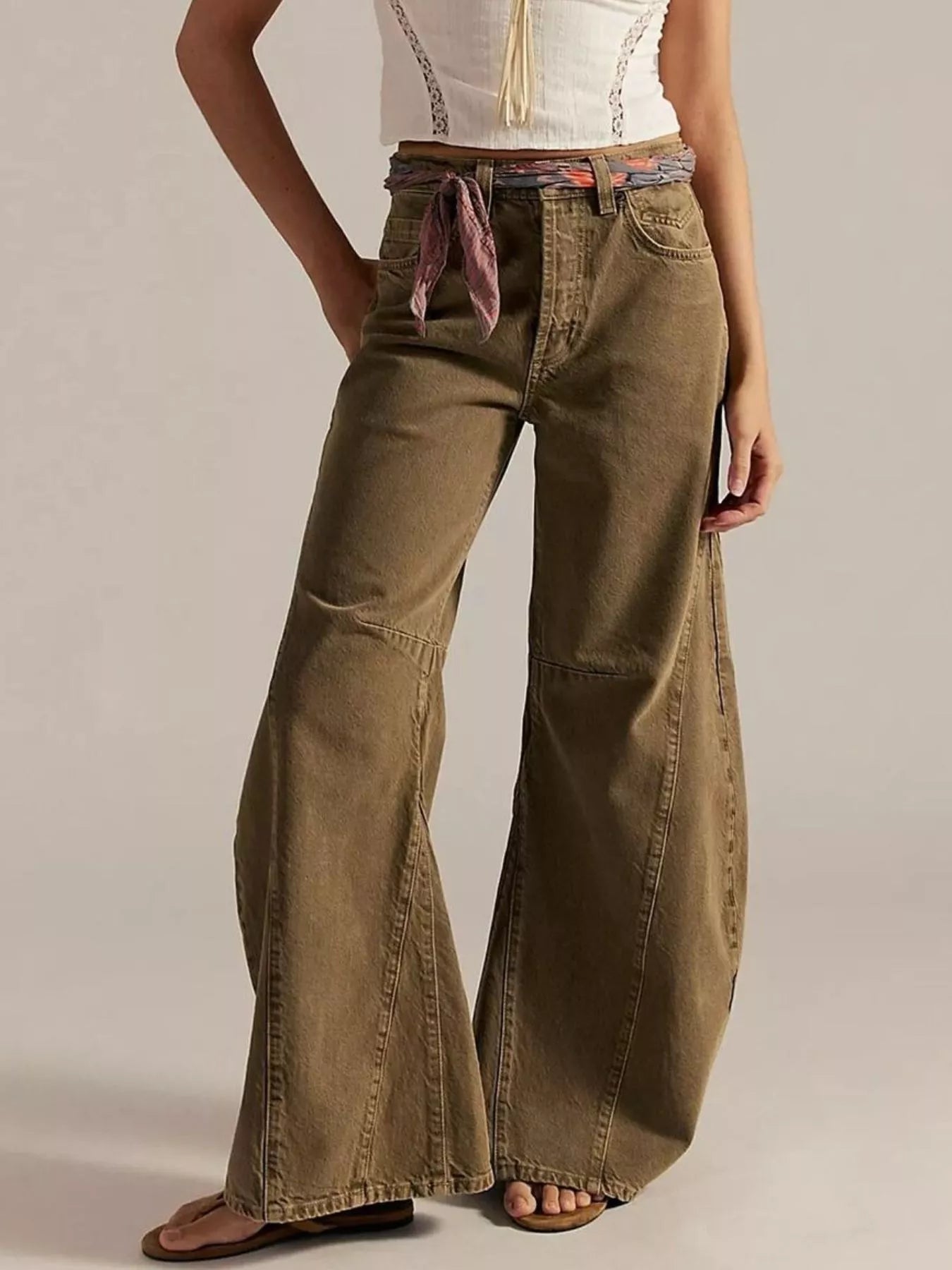 Model wearing Washed Wide Leg Jeans in olive color with a stylish belt and top.