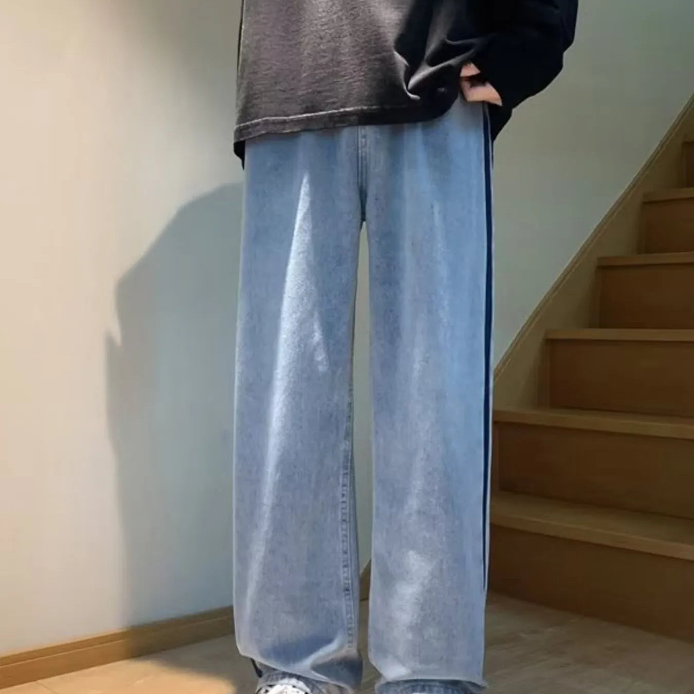 Men's Full Size Side Stripe Loose Fit Jeans Plus Size in light blue worn with a black oversized shirt.