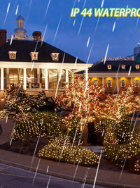 Beautifully illuminated building with waterproof LED string lights during rain, creating a festive atmosphere.