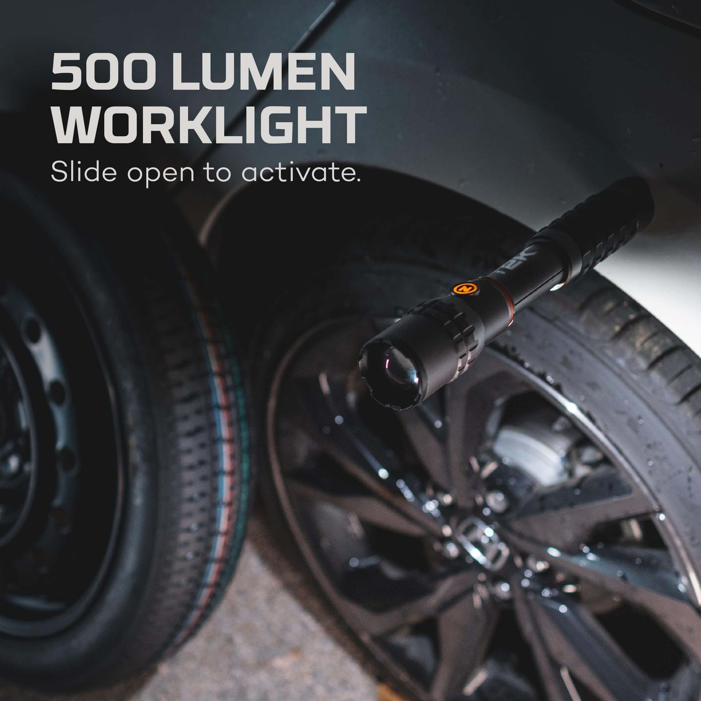 500 lumen worklight activated by sliding, mounted on a vehicle next to a black wheel.