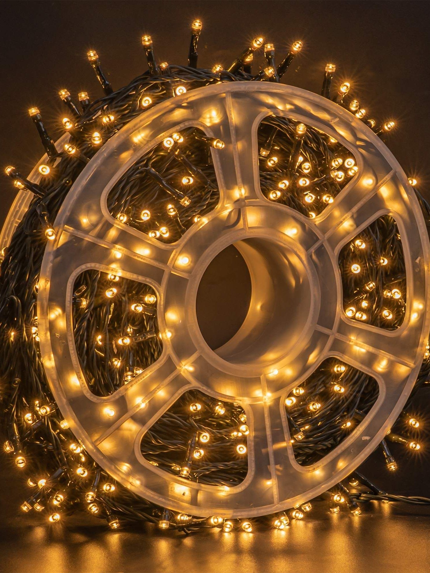 FUNPENY 500 LED warm white string lights on a spool, perfect for indoor and outdoor Christmas decoration.