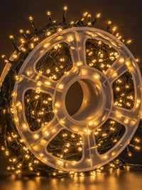 FUNPENY 500 LED warm white string lights on a spool, perfect for indoor and outdoor Christmas decoration.