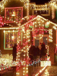 Brightly lit house decorated with colorful Christmas lights and festive decorations, creating a cheerful holiday atmosphere.