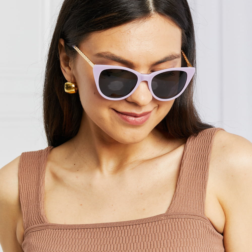 Cat-Eye Acetate Frame Sunglasses worn by a model with brown top and earrings.