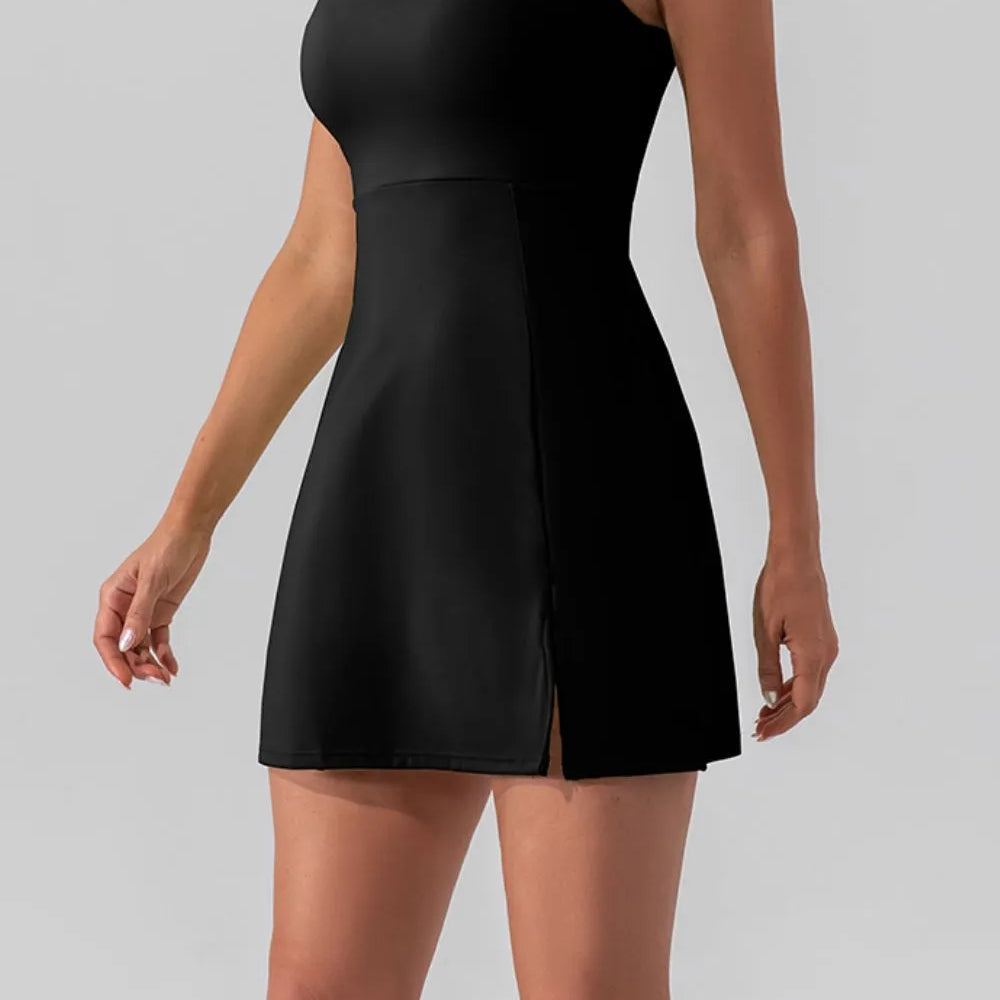 Model wearing a Square Neck Sleeveless Slit Mini Active Dress in black, showcasing its sleek design and stylish slit.