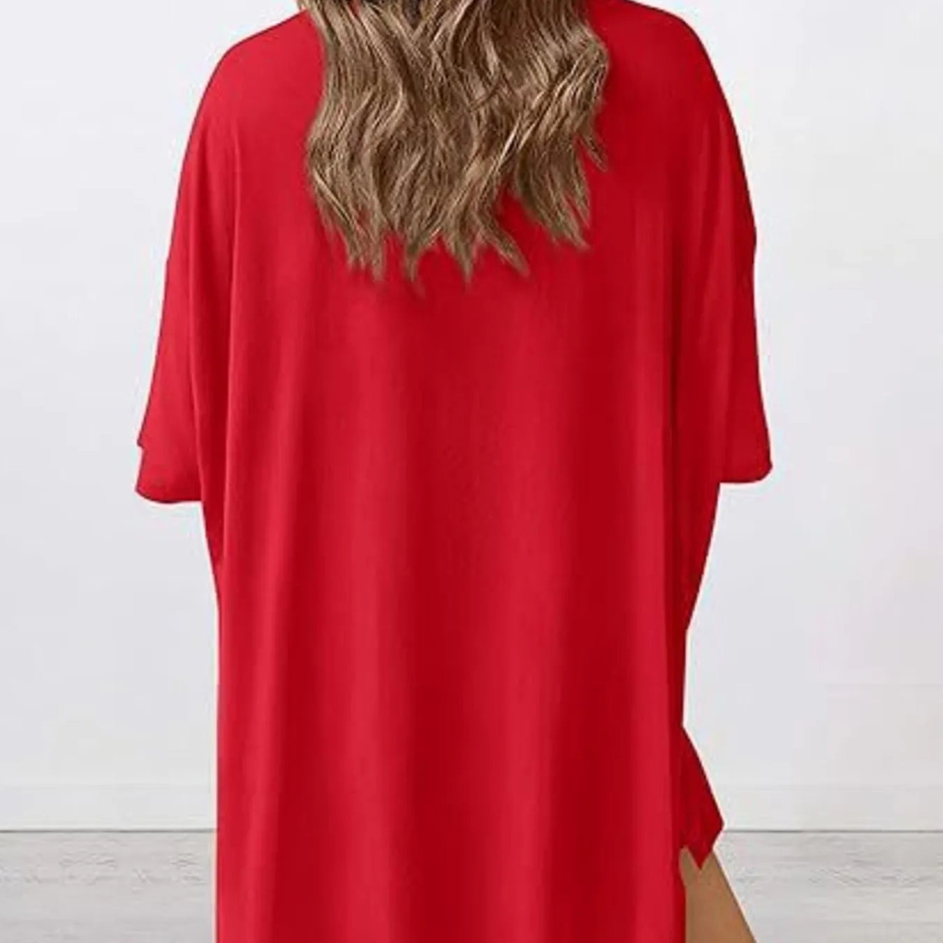 Woman wearing a Full Size Oversized Slit Round Neck Top and Shorts Lounge Set Plus Size in red from the back view.