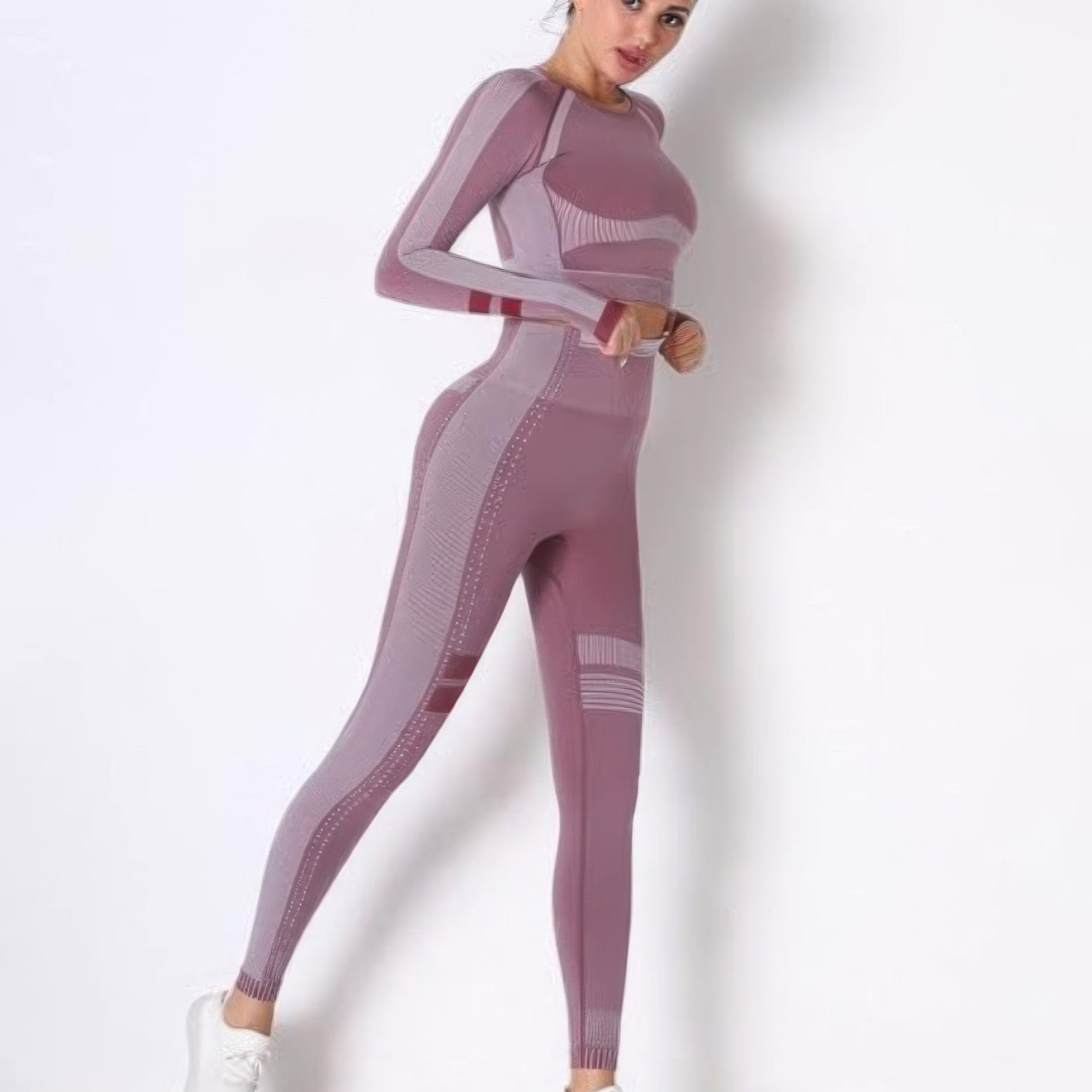 Model wearing a seamless long sleeve yoga set in mauve, showcasing the fitted long sleeve crop top and high-waisted leggings.