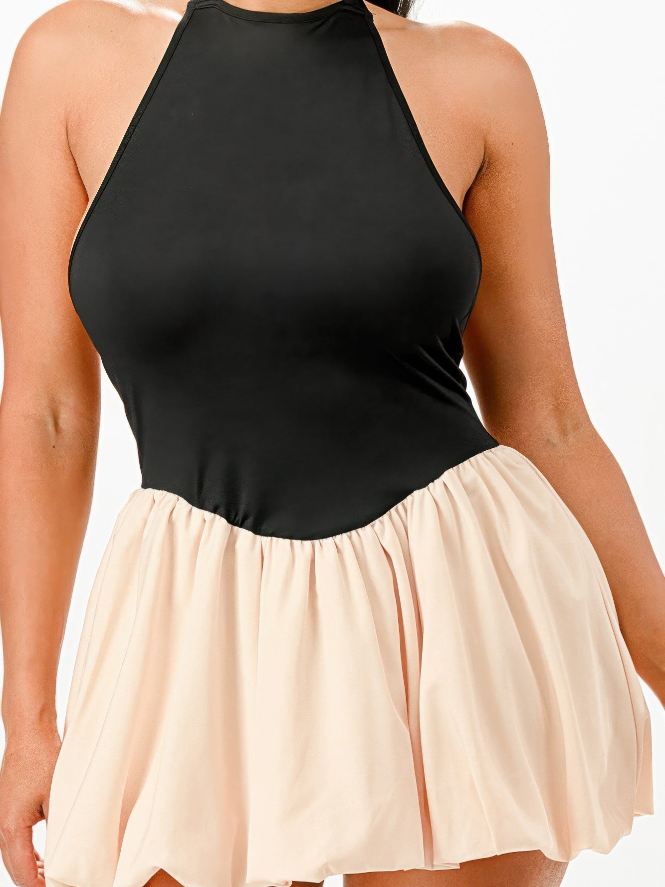 Bubble Mini Dress featuring a black halter top and a flowing beige skirt, perfect for a stylish and comfortable outfit.