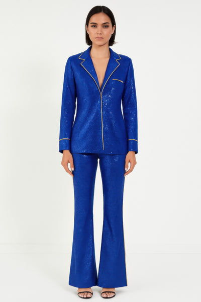 Woman's Resort Wear Pant Set in blue sequined fabric, featuring a collared top and flared pants for a stylish look.