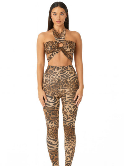 Model wearing the Leopard Cheetah Intertwined Set featuring a halter crop top and fitted leggings.