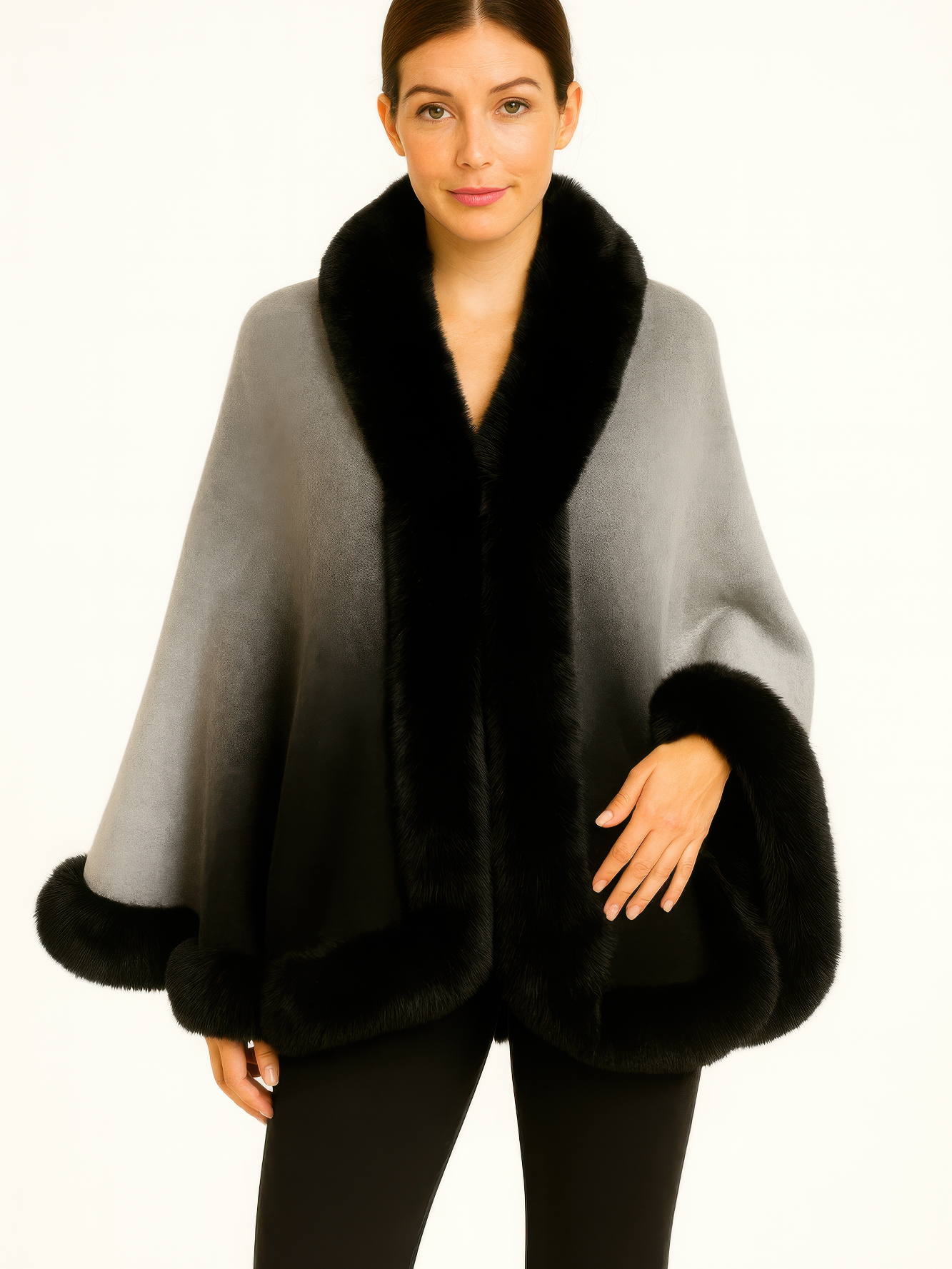 Ombre Faux Fur Trim Cape Wrap worn by a model, featuring a soft ombré grey body with plush black faux fur trim.