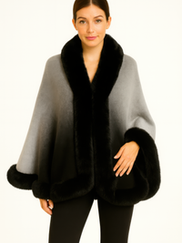 Ombre Faux Fur Trim Cape Wrap worn by a model, featuring a soft ombré grey body with plush black faux fur trim.
