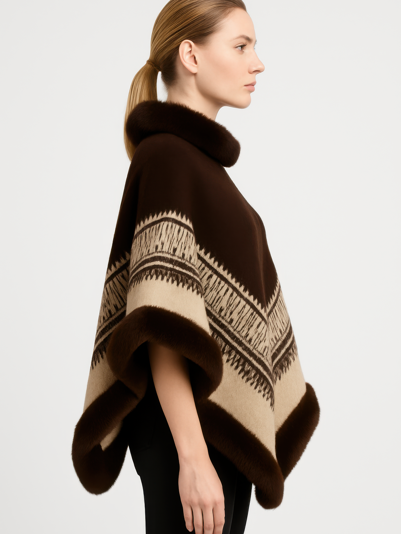 Chevron Trim Poncho With Faux Fur Collar in rich brown with elegant chevron pattern, worn by a model in profile.