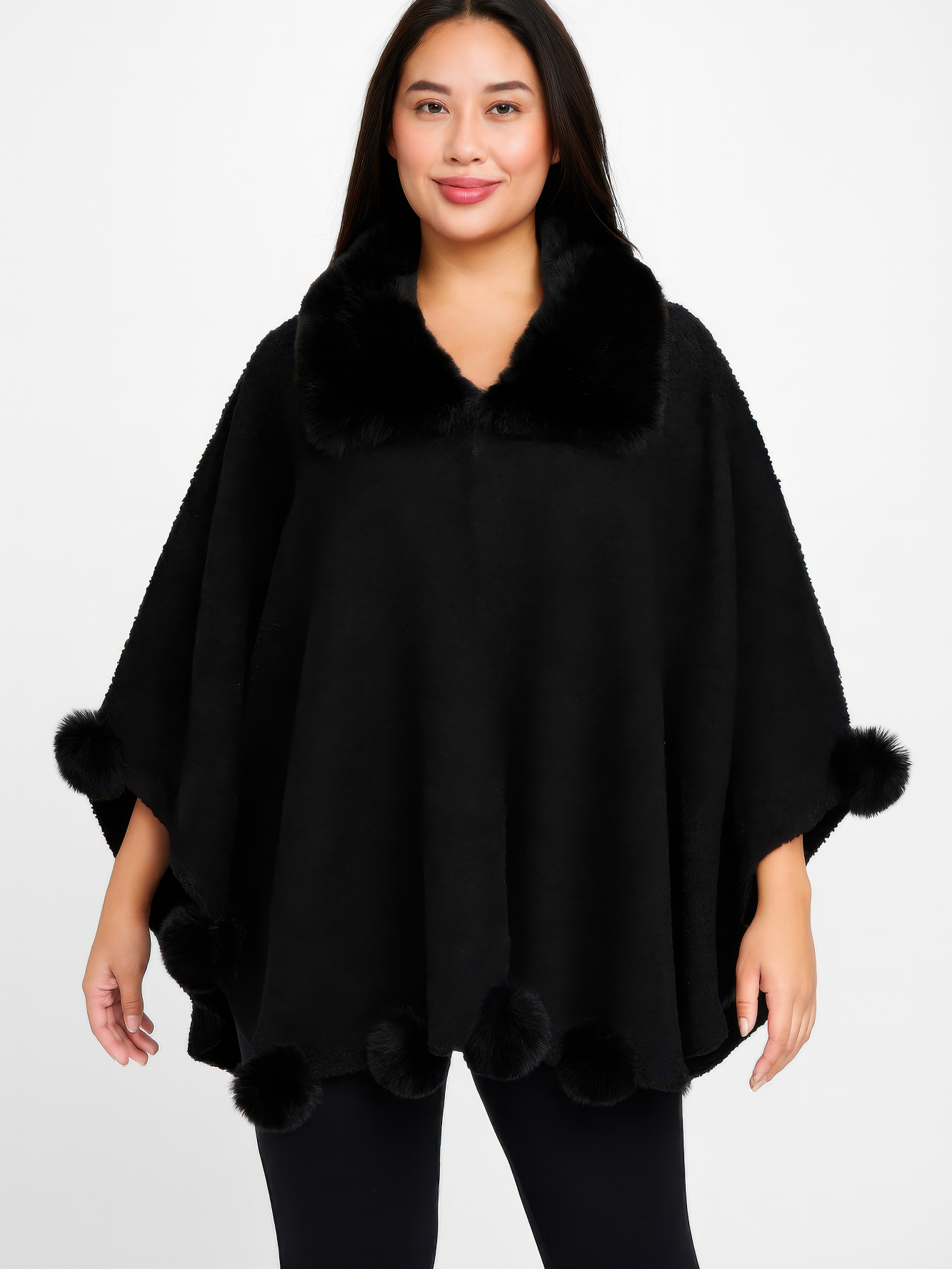 Trim Cape With Faux Fur Collar model wearing a black bouclé cape with pom trim and faux fur collar.