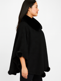 Trim Cape With Faux Fur Collar worn by a model, showcasing its elegant design and cozy texture.