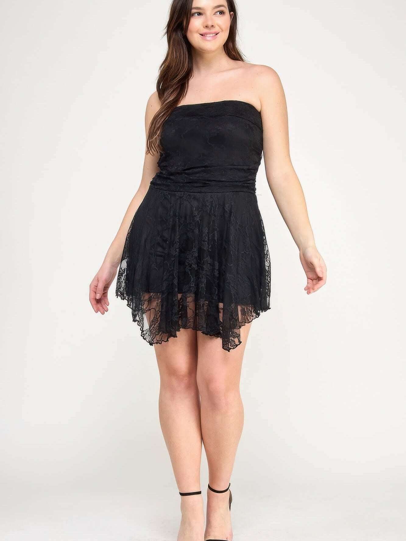 Plus Size Ots Lace Overlay Assym Dress modeled by a woman with a flowing skirt and lace details.