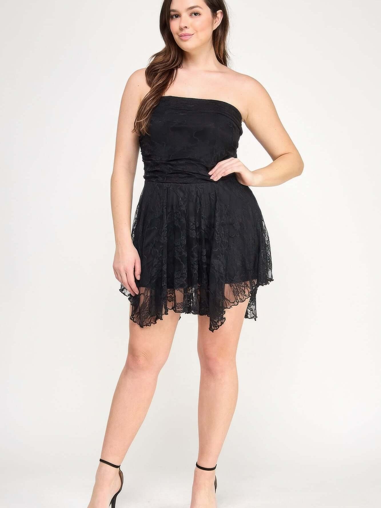 Plus Size Ots Lace Overlay Assym Dress on a model with a stylish black lace design and asymmetrical hem.