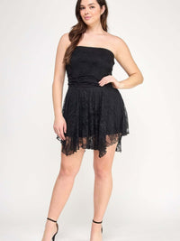Plus Size Ots Lace Overlay Assym Dress on a model with a stylish black lace design and asymmetrical hem.