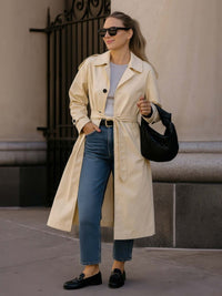 Solid Long Sleeve Trench Coat Woman Lined in beige worn with jeans and sunglasses, exuding chic style.