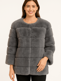 Model wearing a stylish plush camel faux fur jacket, showcasing its cozy sophistication and modern design.