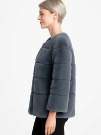 Plush Camel Faux Fur Jacket displayed by a model, showcasing its modern collarless design and soft texture.