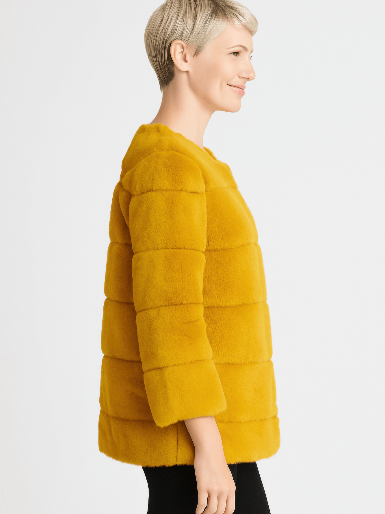 Side view of a woman wearing a Plush Camel Faux Fur Jacket, showcasing its modern design and soft texture.