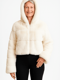 Model wearing a stylish ivory Faux Fur Hooded Jacket with zip-up front and cozy hood.