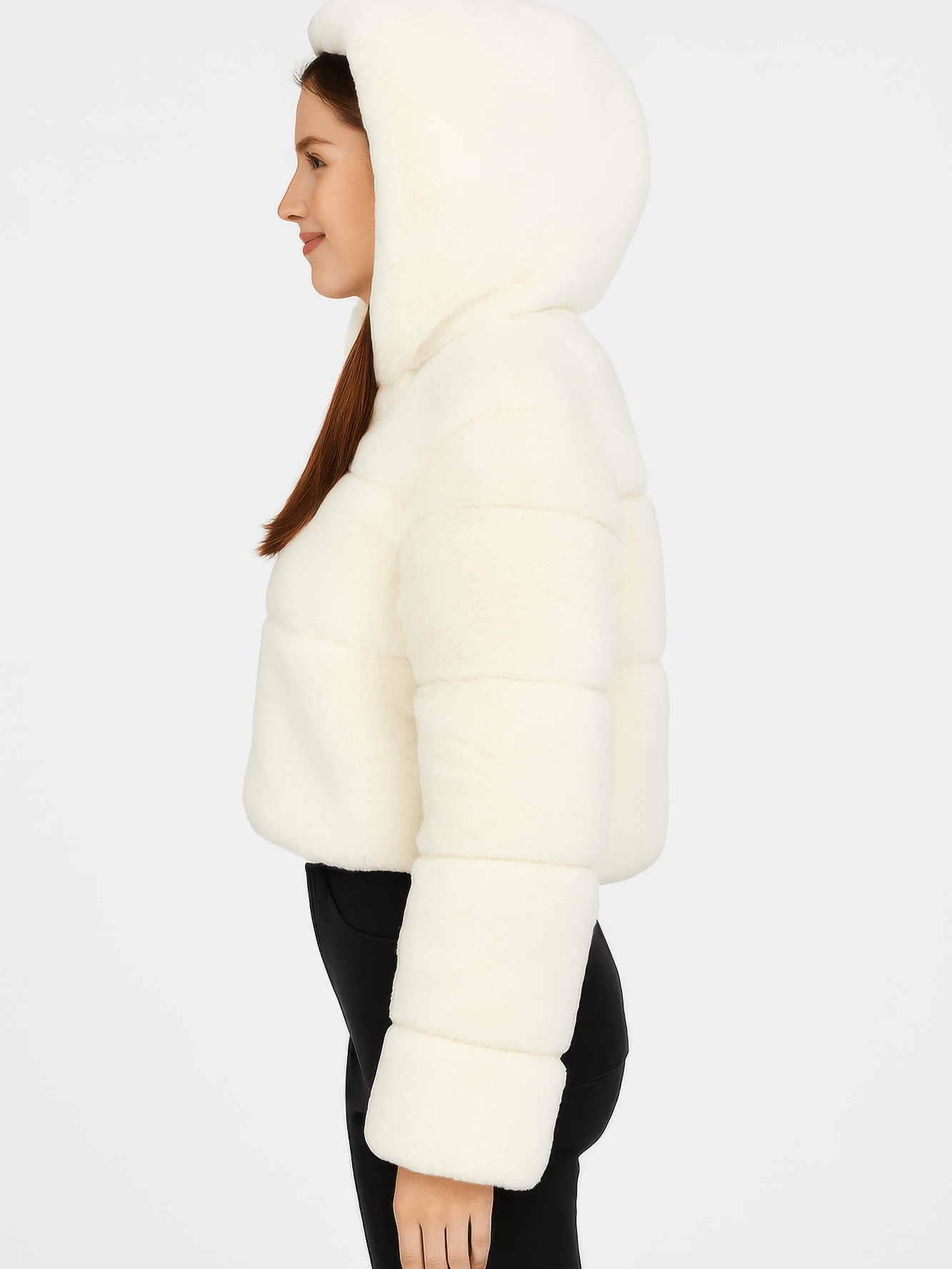 Side view of a woman wearing a warm faux fur hooded jacket in ivory, showcasing its cozy texture and stylish design.