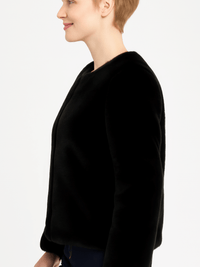 Model wearing a stylish black Faux Fur Trim Cape, showcasing its elegant silhouette and luxurious design.