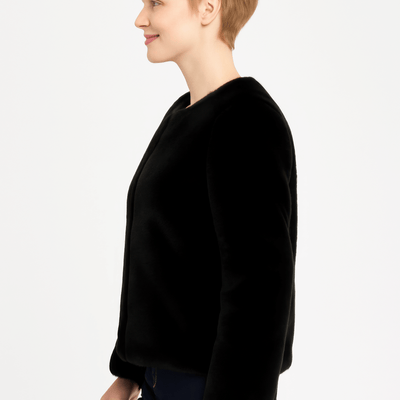 Model wearing a stylish black Faux Fur Trim Cape, showcasing its elegant silhouette and luxurious design.